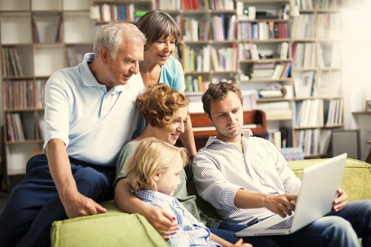 Three-generation family making projects together, representing how to talk to your parent about assisted living with care and respect.